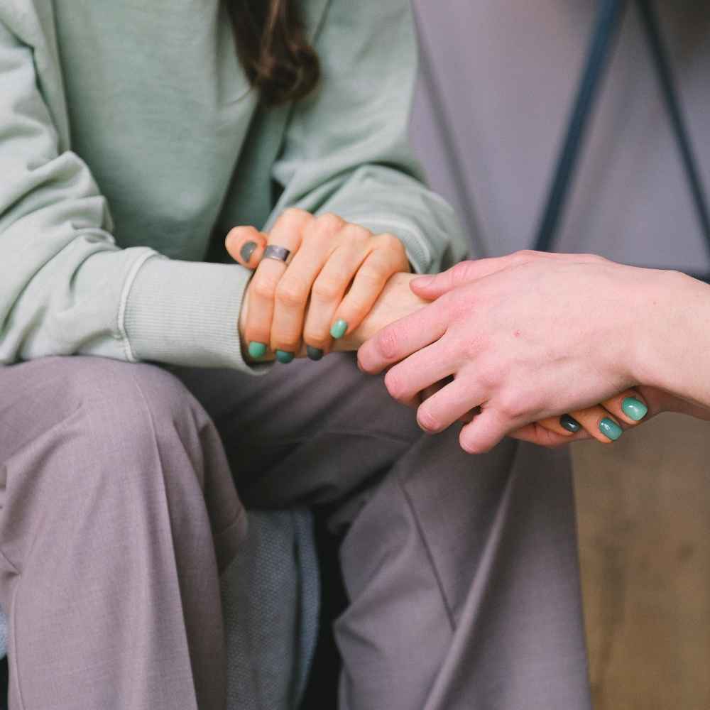 Girl holding woman's hand